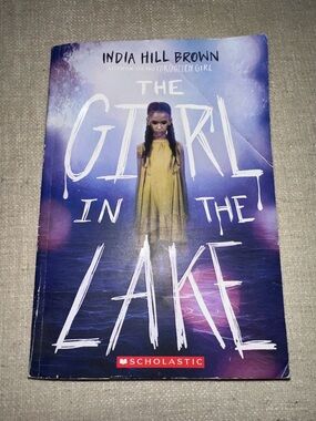 3/$10 The Girl in the Lake by India Hill Brown - Purple Cover